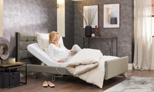 Lady sitting up in a Signature profiling carer bed